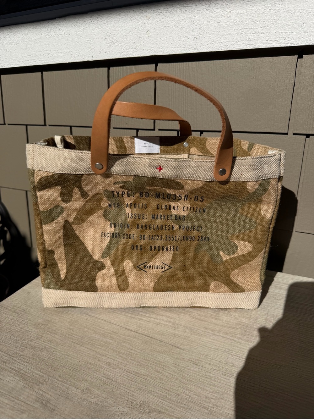 Apolis Global Citizen Market Bag in a safari camo print with tan leather handles